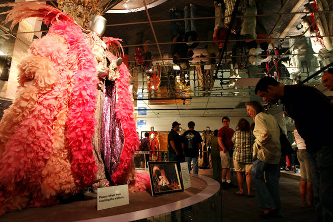 Fans admire the feathered capes and bejeweled costumes of Liberace while visiting the Liberace Museum during its final hours of business Sunday, October 17, 2010, after 31 years in Las Vegas.