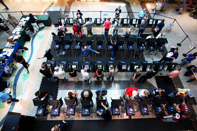 Early voters fill the Galleria at Sunset mall voting station Saturday, the first day of early voting. Whether Hispanic voters turn out to vote in large numbers could be pivotal in the race between Senate Majority Leader Harry Reid and Republican challenger Sharron Angle.