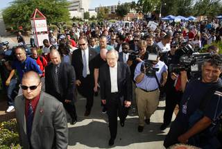 Senate Majority Leader Harry Reid, center, leads a group to an early voting polling place during a rally at UNLV Tuesday, October 19, 2010. Reid faces Republican challenger Sharron Angle in the general election.