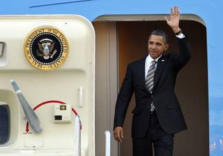 President Barrack Obama waves after landing at McCarran International Airport in Las Vegas Friday, October 22, 2010. Obama will speak at a 