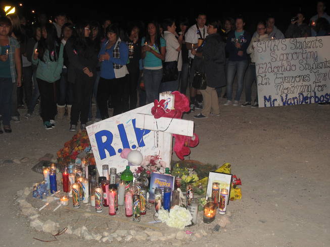 Eldorado High School students and staff gather around a makeshift memorial for teacher Timothy VanDerbosch, who was killed Wednesday while walking to school on Washington Avenue. The memorial walk and candlelight vigil began at 6 a.m. Monday and drew hundreds of people.