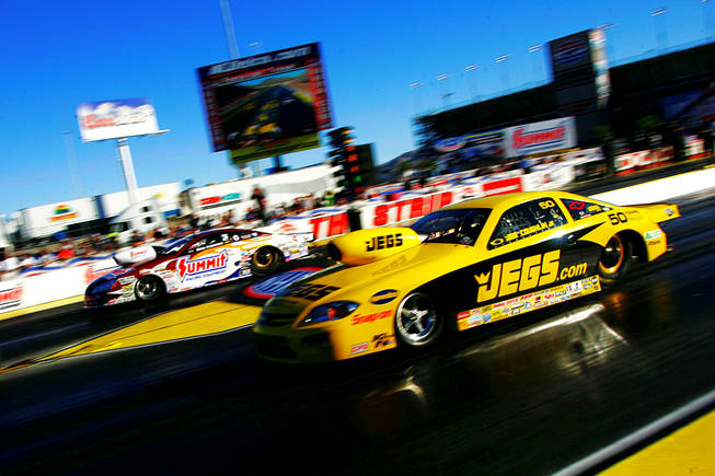 Eventual winner Greg Anderson, left, and Jeg Coughlin race during the finals of the 2010 NHRA Las Vegas Nationals Sunday, October 31, 2010 at the Las Vegas Motor Speedway.
