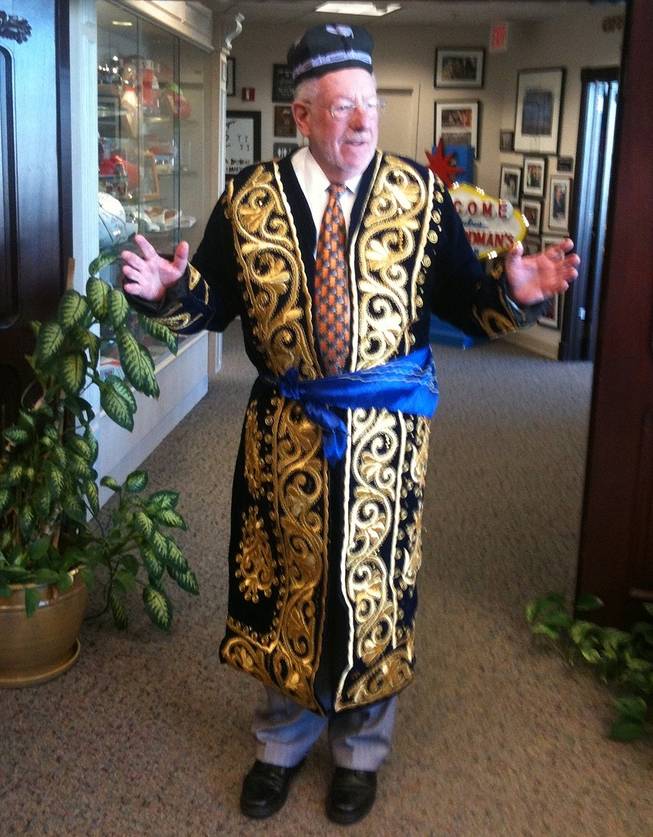 In this mobile phone photo, Las Vegas Mayor Oscar Goodman shows reporters a robe brought to him as a gift recently by a visiting dignitary from Uzbekistan. "I feel very royal and regal," said Goodman,  who is leaving office in 2011 after 12 years because of term limits. Goodman says he expects the field to be crowded for those wanting to succeed him in next spring's municipal election. 