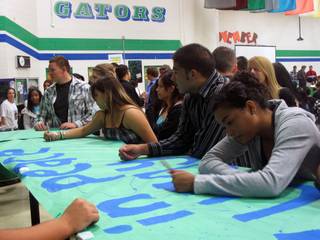 Green Valley High School students and alumni sign a banner dedicated to David 