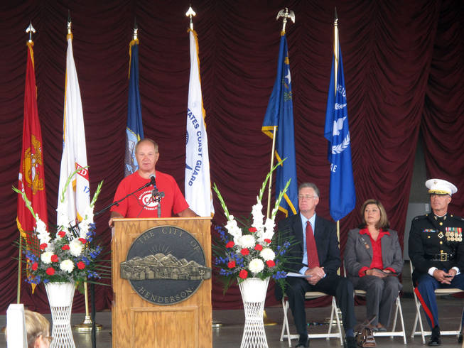 Duane Wagner speaks Saturday at the Henderson Veterans Day Ceremony while, from left, Mayor Andy Hafen, Councilwoman Gerri Schroder and Lt. Col. Michael Viers, from Basic High School's Junior ROTC program, look on. Wagner lost both his legs in Vietnam, but has since ridden a bike across the country.
