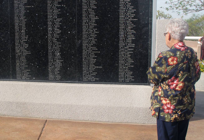 Henderson resident Joyce Nies looks at the Henderson Veterans Memorial Wall following the city's annual Veterans Day Ceremony. Both of Nies former husbands served in the military.