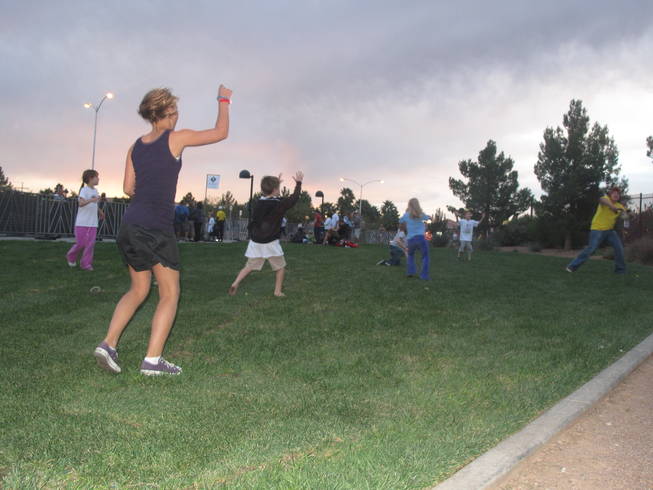 Children play catch with a football near the finish line of the Nevada Silverman Triathlon in Henderson on Sunday. The triathlon began at 7 a.m. Sunday at Lake Las Vegas.