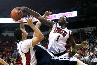 UNLV forward Quintrell Thomas rejects a shot by Washburn forward Bobby Chipman during an exhibition game Tuesday. UNLV won the game 88-53.