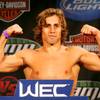 Urijah Faber flexes on the scale during the weigh in for WEC 52 Wednesday, November 10, 2010 at the Palms.
