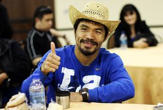 Filipino boxer Manny Pacquiao gives a thumbs up Wednesday night after the final press conference in Dallas November 10, 2010.
