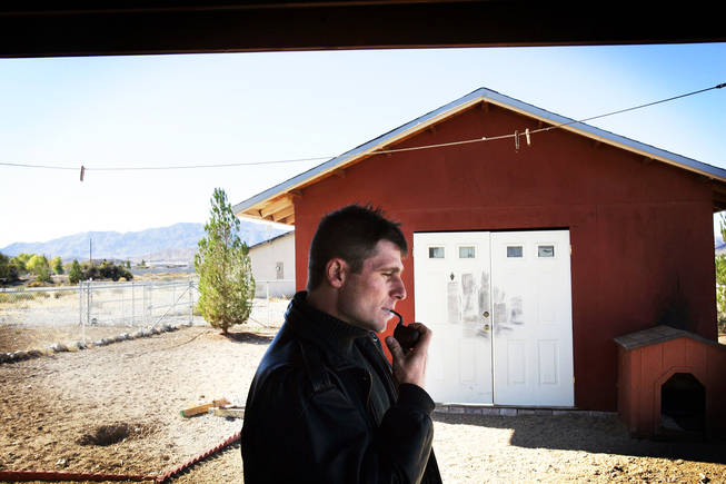 Vadim Bolotsky smokes a pipe in the backyard of his home in Pahrump November 11, 2010.