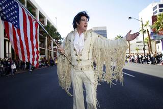 Elvis impersonator James Rompel sings God Bless America as he leads the VFW Post 1753 Happy Hoofers and Friends during a Veterans Day parade in downtown Las Vegas Thursday, November 11, 2010.