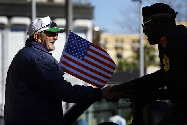 William Preston, left, shakes the hand of a parade participant during a Veterans Day parade in downtown Las Vegas Thursday, November 11, 2010.