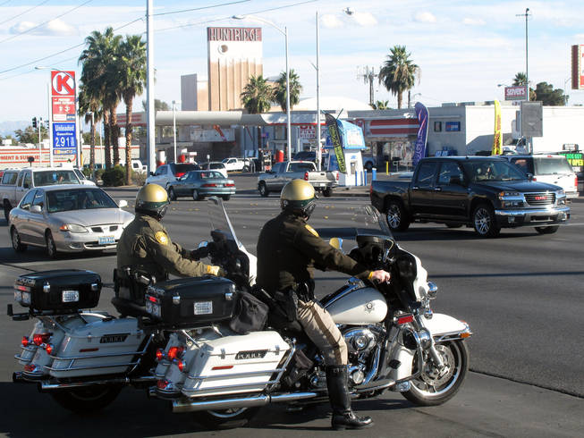 Metro Police officers watch traffic during a crosswalk enforcement campaign Tuesday on Charleston Boulevard.