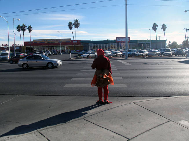 Officer Michael Lemley waits to cross Charleston Boulevard dressed in a turkey costume as part of an enforcement campaign Tuesday.