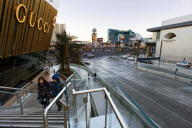 A couple climbs stairs to a pedestrian walkway at the entrance of CityCenter on Wednesday, November 23, 2010. 