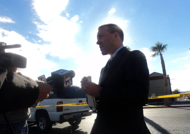 Henderson police spokesman Keith Paul talks to the news media Wednesday after police responded to reports of two bloody men in the parking lot of Chevron, 3061 St. Rose Parkway. 