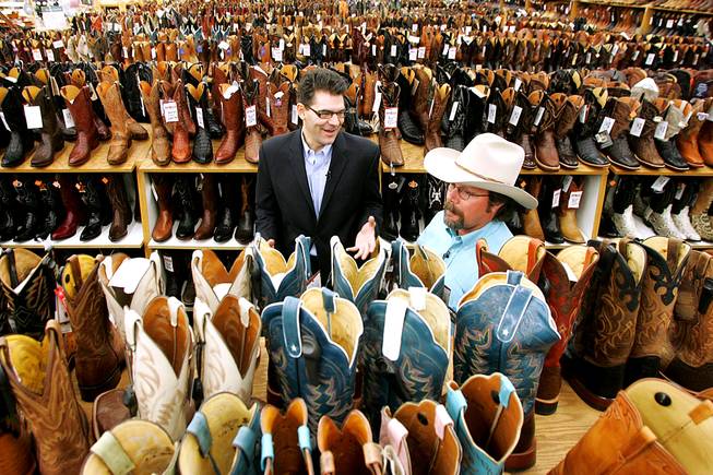 Boot Barn salesman Michael Hull teaches Las Vegas Sun columnist John Katsilometes about cowboy boots as he gets outfitted for the National Finals Rodeo on Wednesday, Nov. 24, 2010.