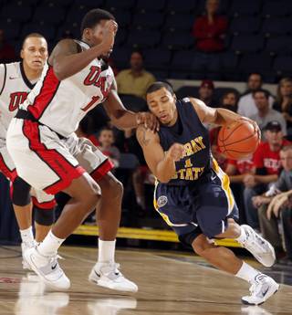 Murray State guard B.J. Jenkins, right, drives around UNLV forward Quintrell Thomas during the first half at the 76 Classic in Anaheim, Calif., Friday, Nov. 26, 2010. 
