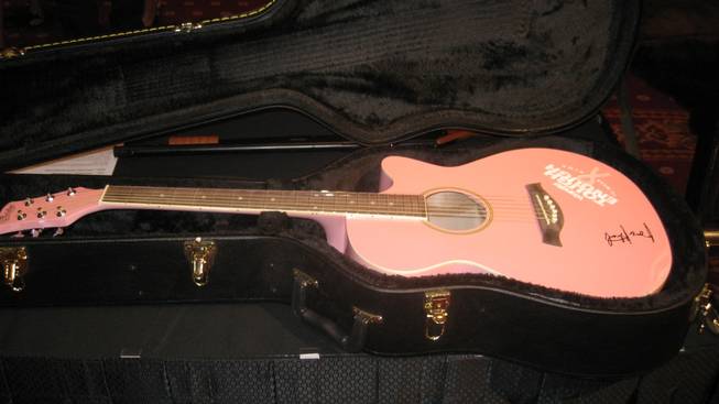 A pink guitar signed by George Strait that went for $1,300 -- which includes tuning.
