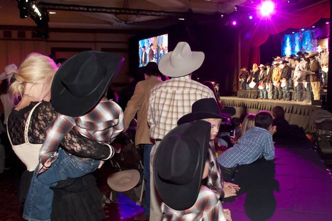 Fans of all ages watch their favorite competitor take the stage during the National Finals Rodeo welcome reception at South Point on Tuesday, Nov. 30, 2010.