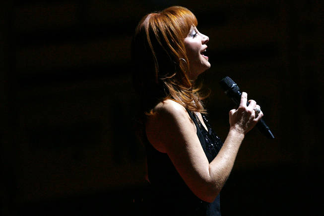 Country star Reba McEntire sings the national anthem at the start of the first go round of the National Finals Rodeo Thursday, December 2, 2010 at the Thomas & Mack.