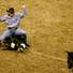 Roper Tuf Cooper throws up his hands after tying his calf during the first go round of the National Finals Rodeo on Thursday, Dec. 2, 2010, at the Thomas & Mack.