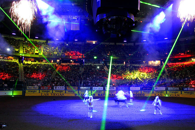 Pyrotechnics, lasers and dancers entertain the crowd at the start of the first go round of the National Finals Rodeo Thursday, December 2, 2010 at the Thomas & Mack.