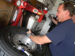 John Tommilla, a member of BP Goodrich's team, tightens the torque on a tire during Friday's technical inspections and contingency for the Henderson TransWest 250.