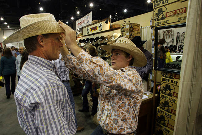 Adam Fitze, right, 18, gives advice to his father Dennis Fitze on how to shape his hat during the Cowboy Christmas Gift Show at the Las Vegas Convention Center on Dec. 3, 2010. The show, affiliated with the Wrangler National Finals Rodeo, runs through Dec. 11.