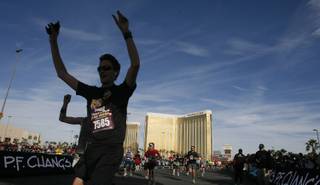 Runners cross the finish line during the Las Vegas half-marathon Sunday, Dec. 5, 2010, in Las Vegas.