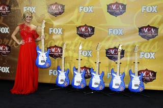 Singer Carrie Underwood poses backstage during the American Country Awards show at the MGM Grand Garden Arena Monday, December 6, 2010. Underwood won six awards including Artist of the Year.
