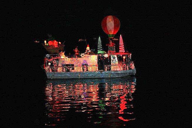 A lighted houseboat sails past Boulder Beach on Saturday, Dec. 4, 2010, at Lake Mead's Christmas Parade of Lights.