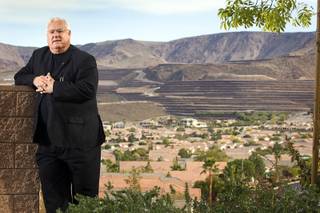 Architect Robert Fielden poses in Henderson December 9, 2010. In the background, the Crystal Ridge development carved terraces into the mountain for custom home sites.