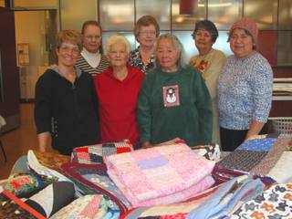 Members of a quilting group at the Heritage Park Senior Center in Henderson pose for a photo on Thursday, Dec. 9, 2010. The group makes quilts and donates them to those in need. In front, from left: Ann Kosewicz, Louise Walder, Blossom Lee; in back, from left: Barbara Collins, Phyllis Ragle, Maria Dissinger, Maria De Walsh.