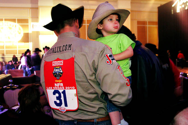 World champion Dean Gorsuch holds his son Trell during the NFR World Champion Awards Show and After Party at The Mirage on Saturday, Dec. 11, 2010.