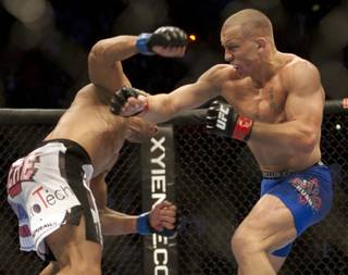 George St-Pierre, right, from Montreal, trades punches with Josh Koscheck, from Waynesburg, Pa., during their welterweight title bout at UFC 124 on Saturday in Montreal. St-Pierre won a unanimous decision to retain his title.