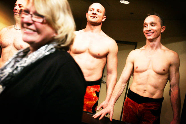Nikolai Melnikov, center, Iouri Safronov, right, and other performers greet fans after "V — The Ultimate Variety Show" at Miracle Mile Shops in Planet Hollywood on Thursday, Dec. 16, 2010.
