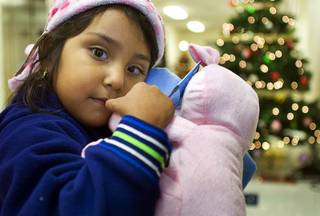 Evelin Camarena, 4, holds new toys at Catholic Charities of Southern Nevada Thursday, December 16, 2010. The Catholic Charities program provided free toys, jackets and other clothing for low-income families.