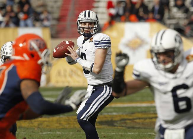 BYU quarterback Jake Heaps looks to pass to McKay Jacobson (6), right, during the first quarter of the New Mexico Bowl NCAA college football game against UTEP, Saturday, Dec. 18, 2010, in Albuquerque, N.M. BYU won, 52-24. 
