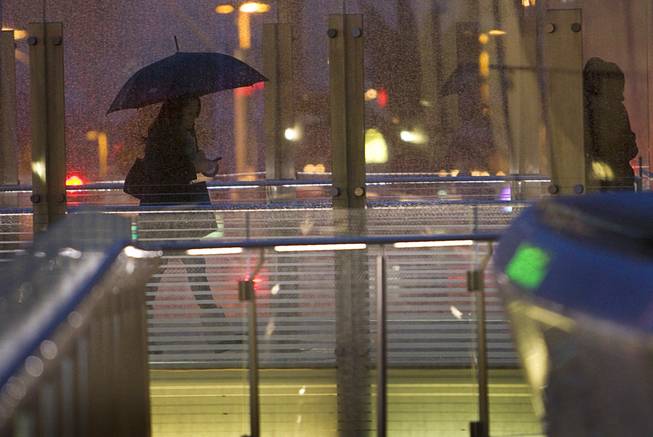 A woman uses a pedestrian walkway at CityCenter on the Las Vegas Strip in the late afternoon Wednesday, Dec. 22, 2010.  