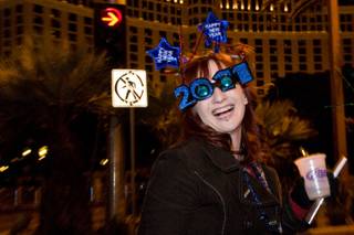 A partygoer wearing festive glasses starts the celebration on New Year's Eve 2010.