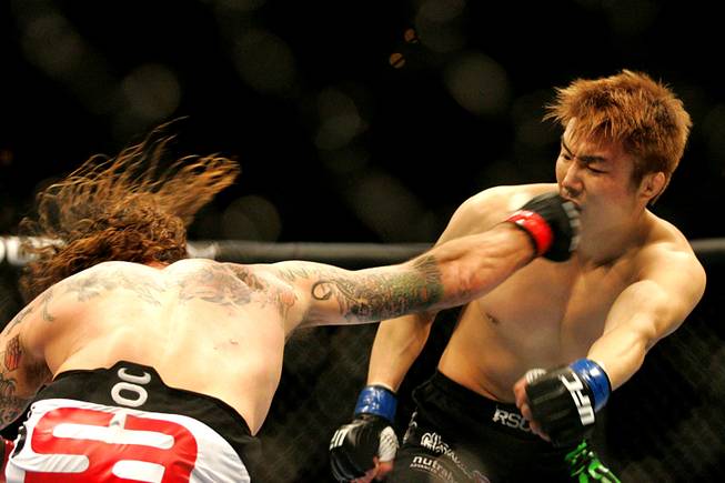 Clay Guida connects with a right on Takamori Gomi  during UFC 125 Saturday, January 1, 2011 at the MGM Grand Garden Arena.  Guida won with a guillotine choke in second round.