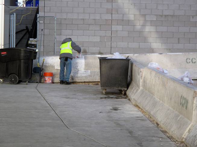 A worker picks up trash near Planet Hollywood on the Las Vegas Strip early on New Year's Day.