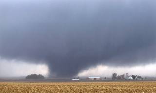 A tornado 2 miles west of Flatville, Ill., moves northeast at 12:51pm. The tornado damaged many farm buildings and homes on its way to Gifford, Ill., where scores of houses were devastated.  (AP Photo/News-Gazette/Jessie Starkey) MANDATORY CREDIT