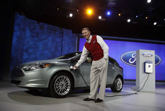 Ford Motor Co. Chairman and CEO Alan Mulally demonstrates plugging in the Ford Focus Electric to a charging station at the International Consumer Electronics Show Friday, Jan. 7, 2011 in Las Vegas. 