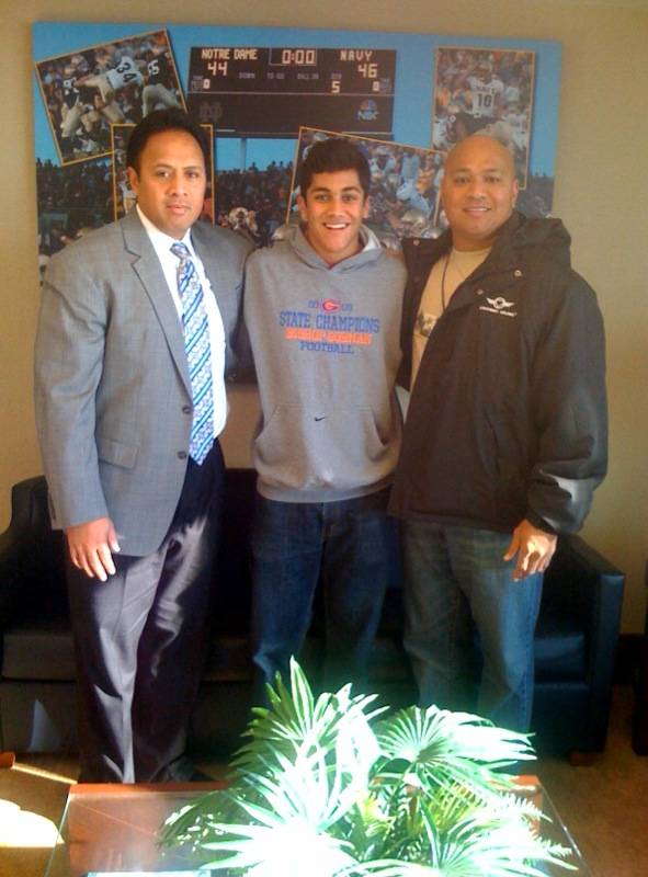 Bishop Gorman High defensive back Togasii Peko (middle) poses for a picture with Navy football coach Ken Niumatalolo (left) and his dad, Tony Peko, during a recruiting trip this weekend. Togasii Peko committed to the Academy at the end of his trip.