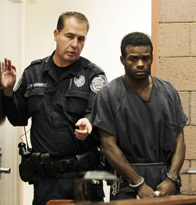 Jason Griffith, right, is directed into the courtroom before his arraignment on strangulation and dismemberment charges Wednesday, Jan. 12, 2011 in North Las Vegas. 