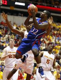 In this Jan. 12, 2011, file photo, Kansas guard Josh Selby (32) shoots over Iowa State forward Jamie Vanderbeken (23), forward Melvin Ejim and guard Jake Anderson (5) during the first half of an NCAA college basketball game in Ames, Iowa. 