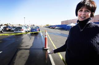 Geena Mattox, chief operating officer at Opportunity Village, looks at the damage after several Opportunity Village vehicles were vandalized. Eight of the nonprofit's vehicles were damaged, including a bus used to transport clients.